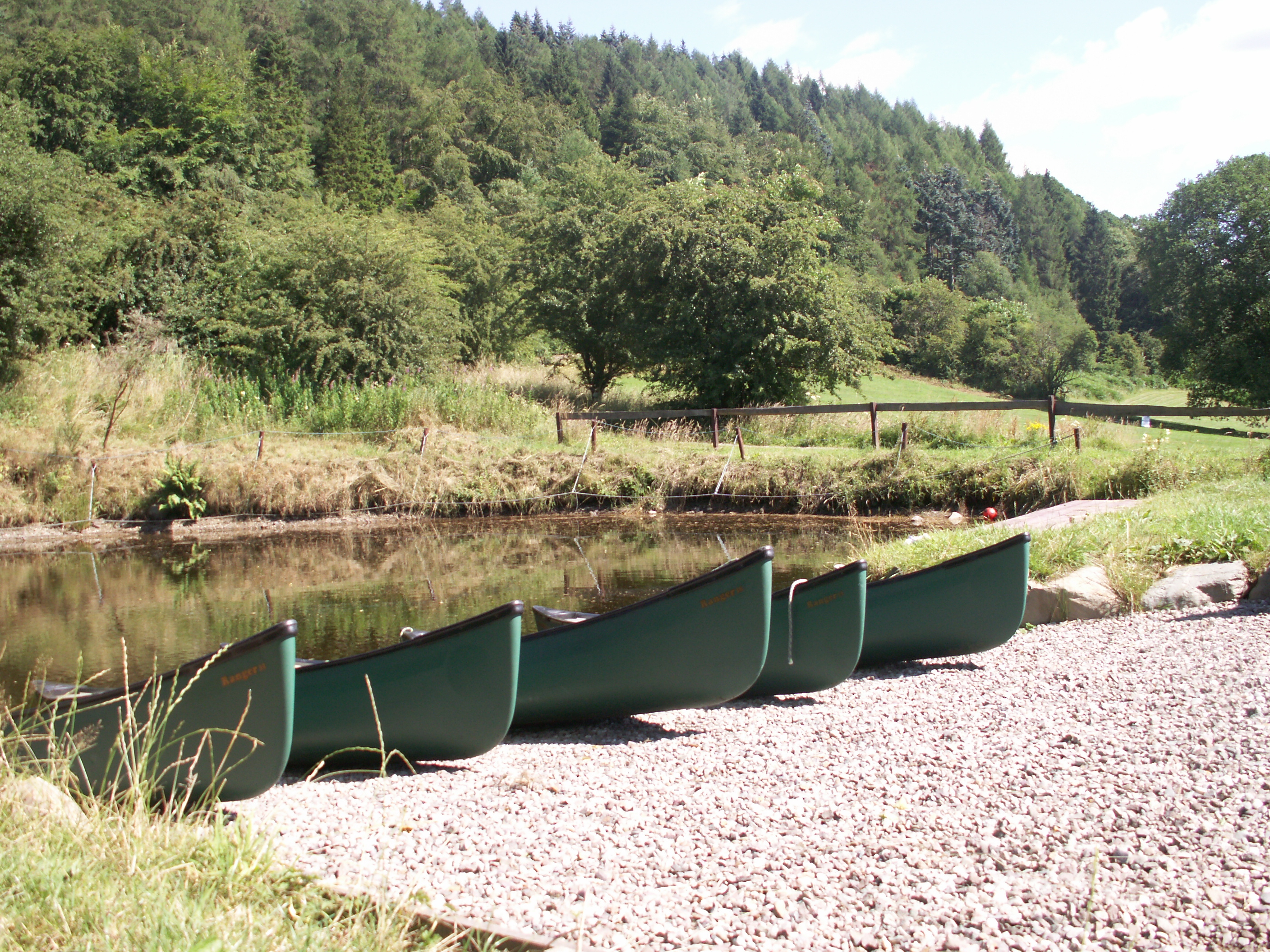 canoes at side of pond 6.JPG